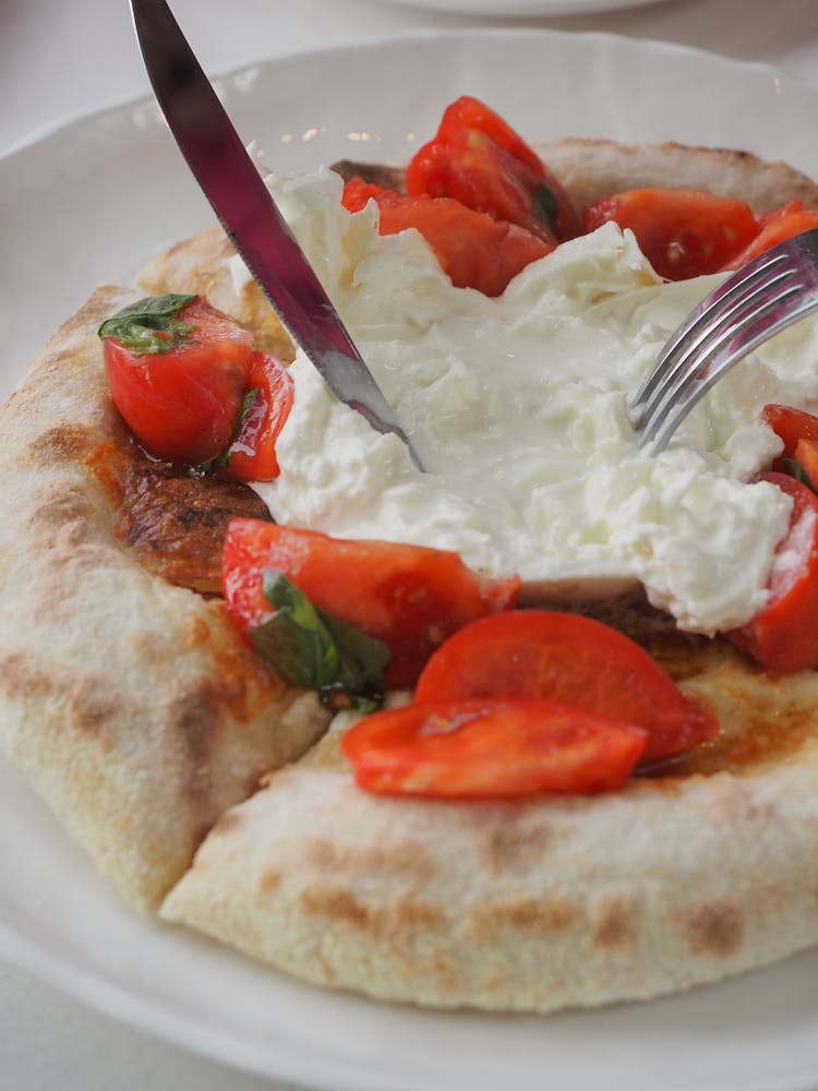 A Bread With Burrata Cheese And Tomatoes