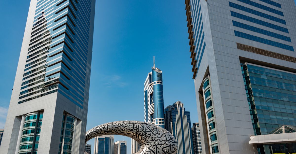 Discover the futuristic architecture amidst Dubai's towering cityscape under a clear blue sky.