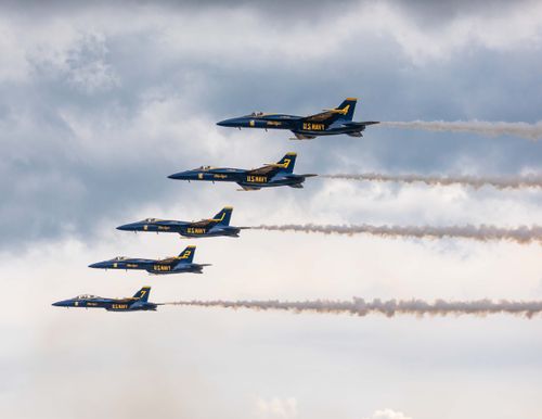 Free Five U.S. Navy Blue Angels jets flying in tight formation against a cloudy sky. Stock Photo