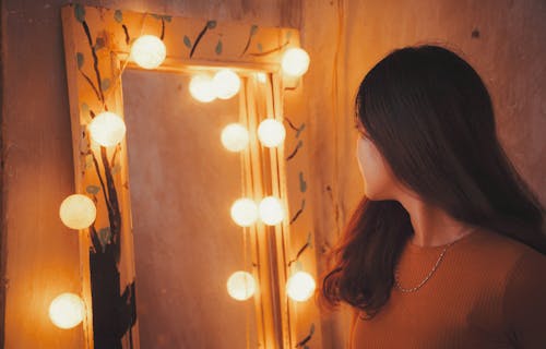 Free Woman Facing Vanity Mirror Stock Photo