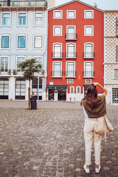 Woman Taking Photo of Buildings