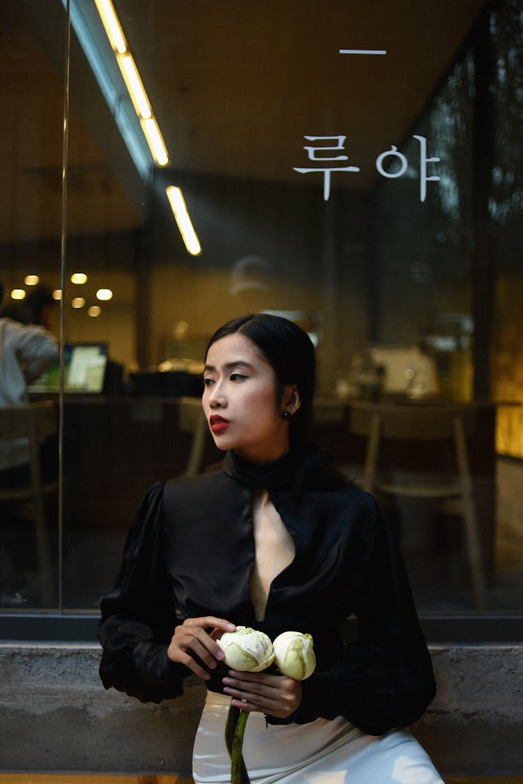 Fashionable Young Woman Holding Flowers