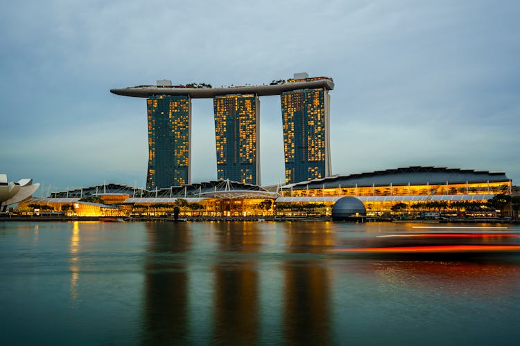 Illuminated Modern City Buildings At Water