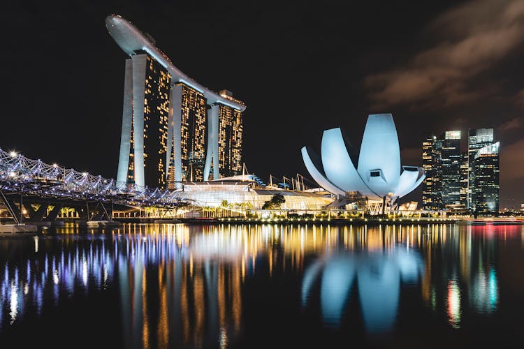 Modern City Buildings In Light Near Water