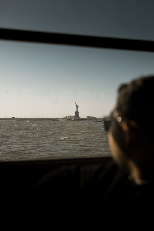 A Person Looking at the Statue of Liberty
