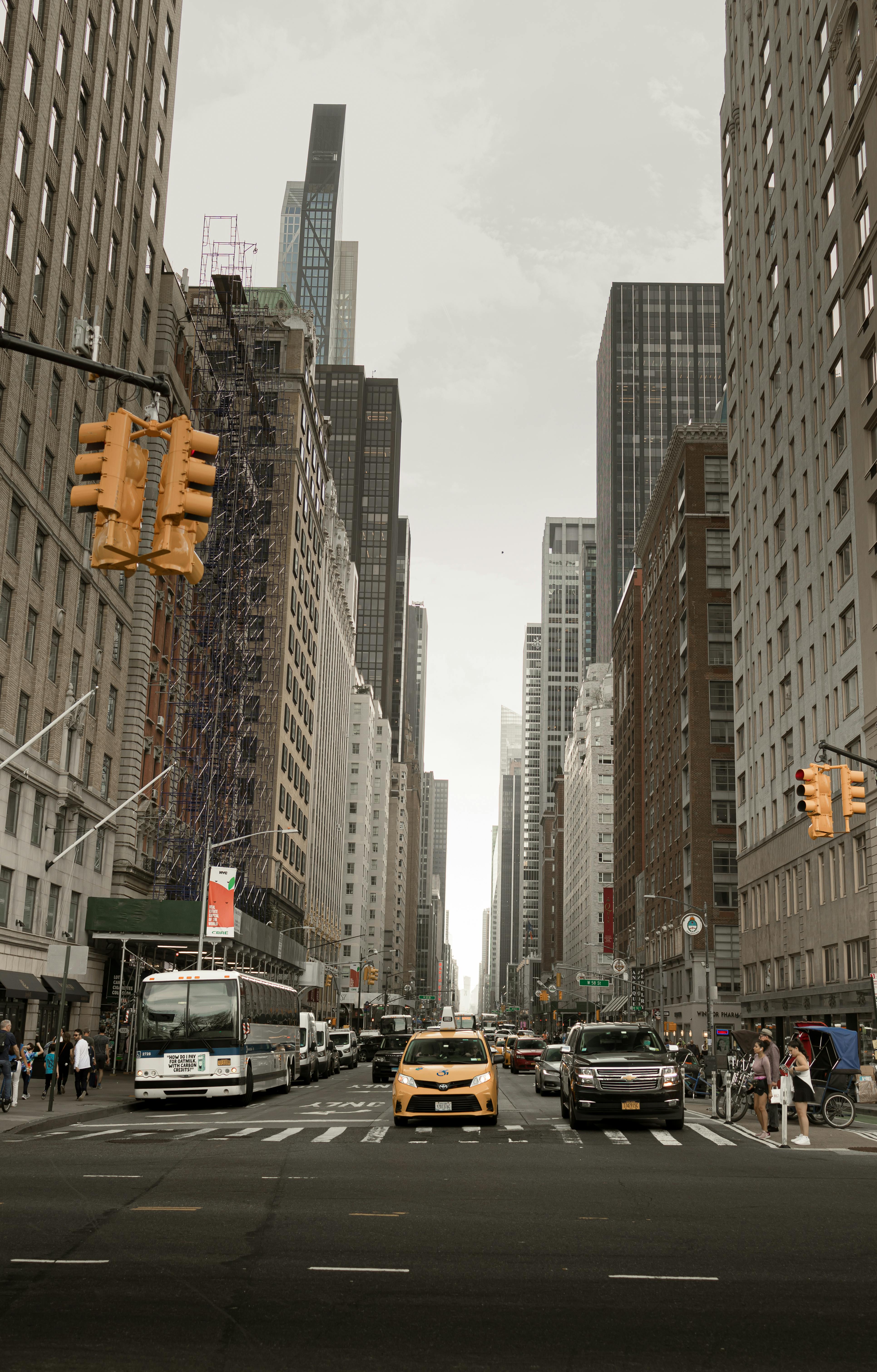 yellow cab between buildings