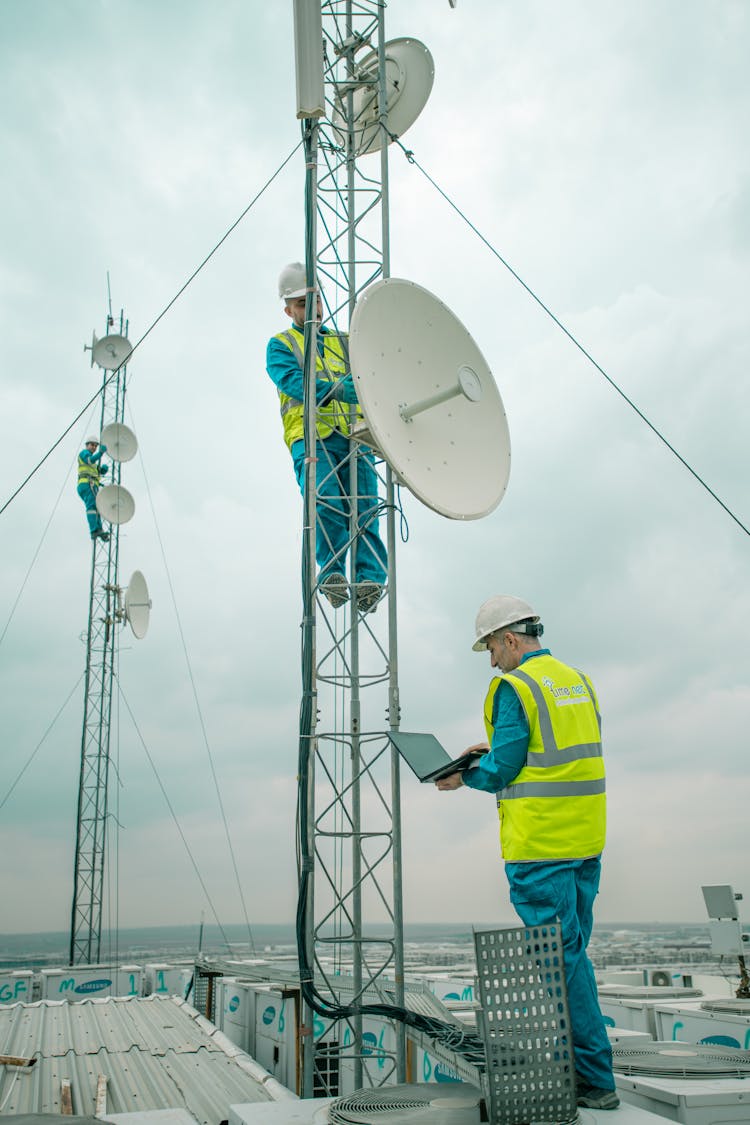 Workers Installing Satellites