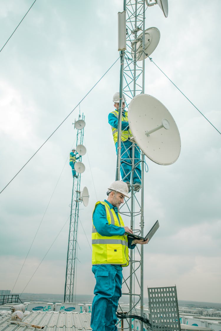 Workers Installing Satellites