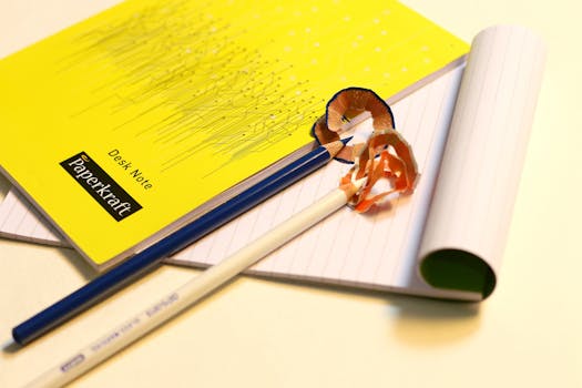 Vibrant stationery set featuring sharpened pencils and labeled notebooks on a desk.