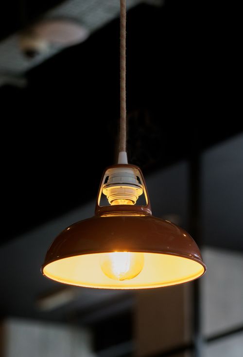 Free Close-up of a vintage hanging lamp casting a warm glow, perfect for home decor. Stock Photo