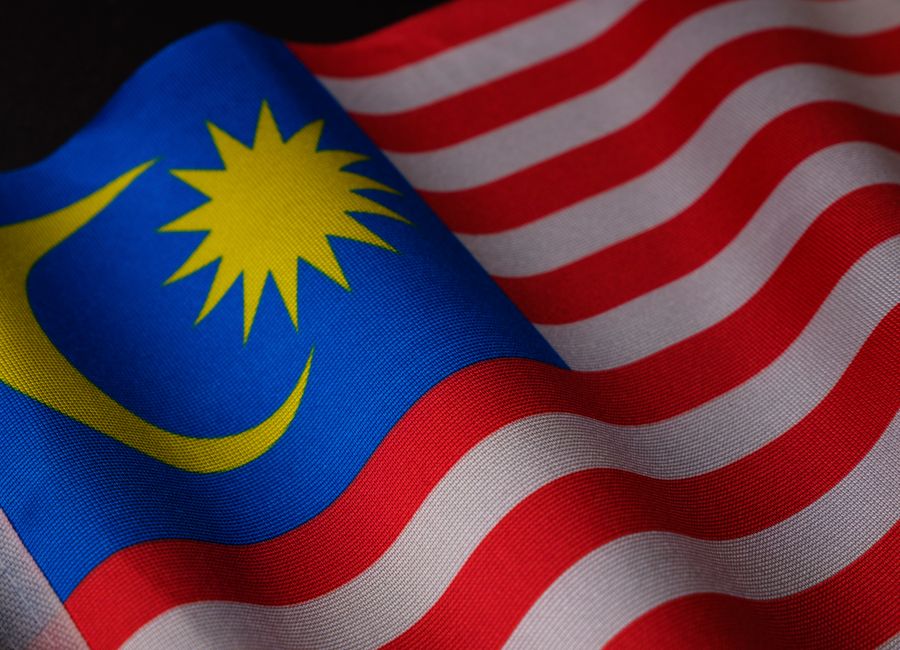 A detailed close-up of the Malaysian flag showing its vibrant colors and waving fabric texture.