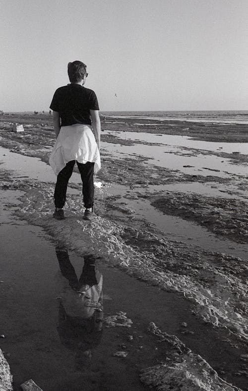 Man Standing on Puddles in Black and White
