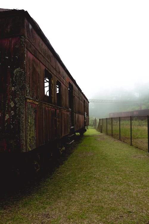 Abandoned, Rusty Train Carriage on a Grass Field 