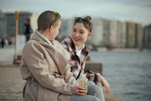 Young Women Sitting on the Beach and Talking 