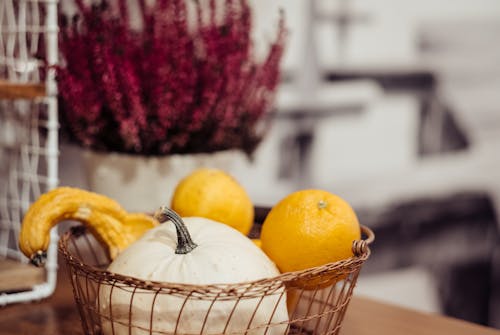 Selective Focus Photography of Orange Citrus Fruits and White Pumpkin in Basket