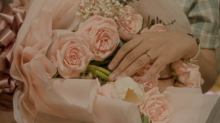 A Hand On Bouquet Of Roses 