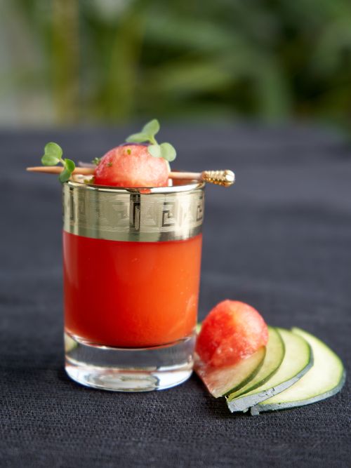 Free A vibrant watermelon tomato juice cocktail garnished with fresh herbs and cucumber slices. Stock Photo