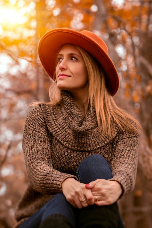 Free Woman Crossing Legs Near Tree during Golden Hour Stock Photo