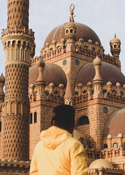 Man Standing in front of Historical Mosque