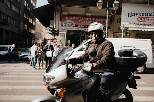 Man on Motorcycle on City Street