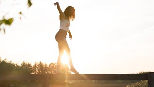 Woman Walking On Fence