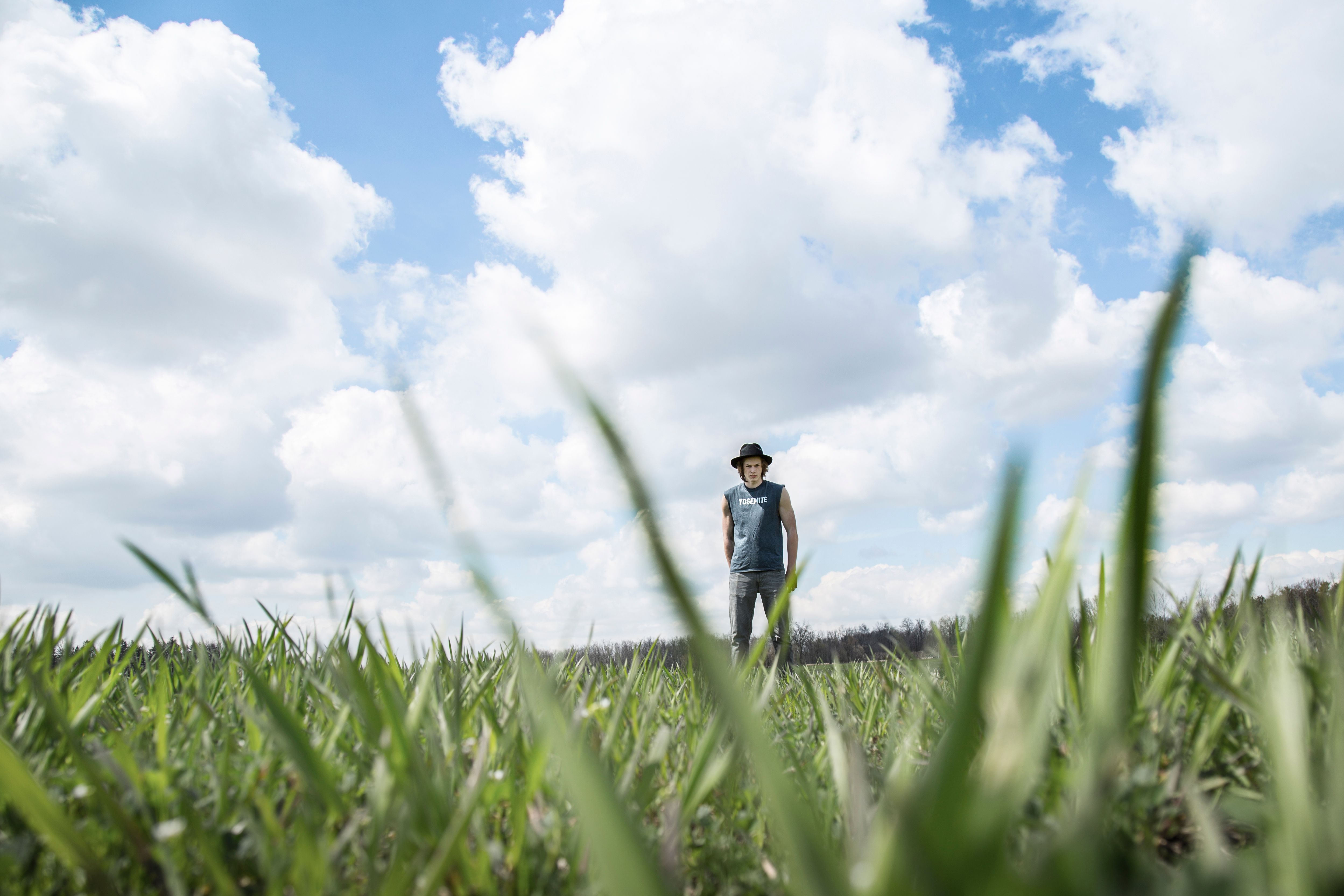 Photo of Person Standing On Grass Field · Free Stock Photo