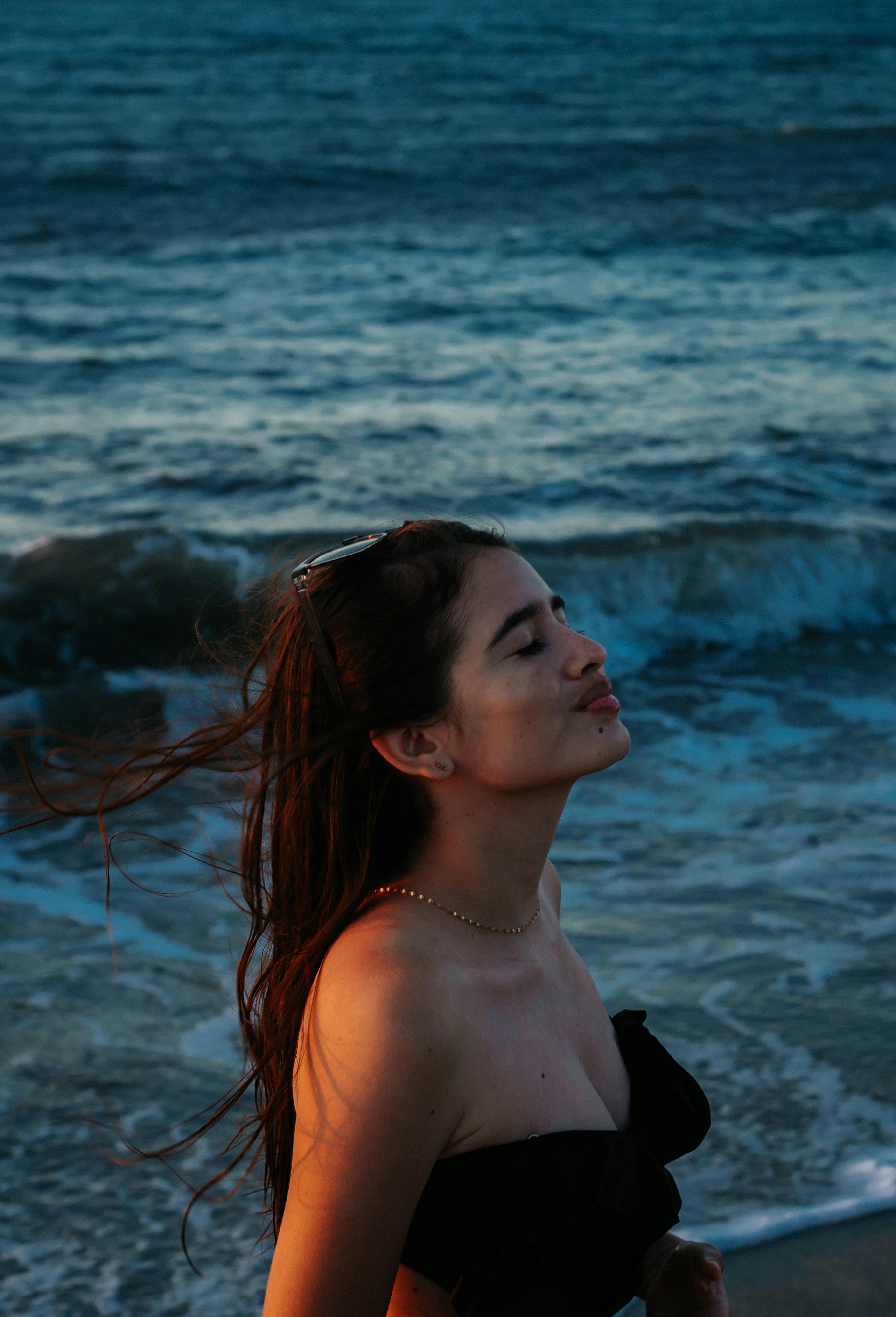 Young woman enjoying the breeze at a beach in Santa Marta, Colombia.