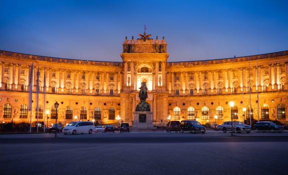 Illuminated view of Hofburg Palace captured during dusk in Vienna, Austria. Beautiful architectural landmark.