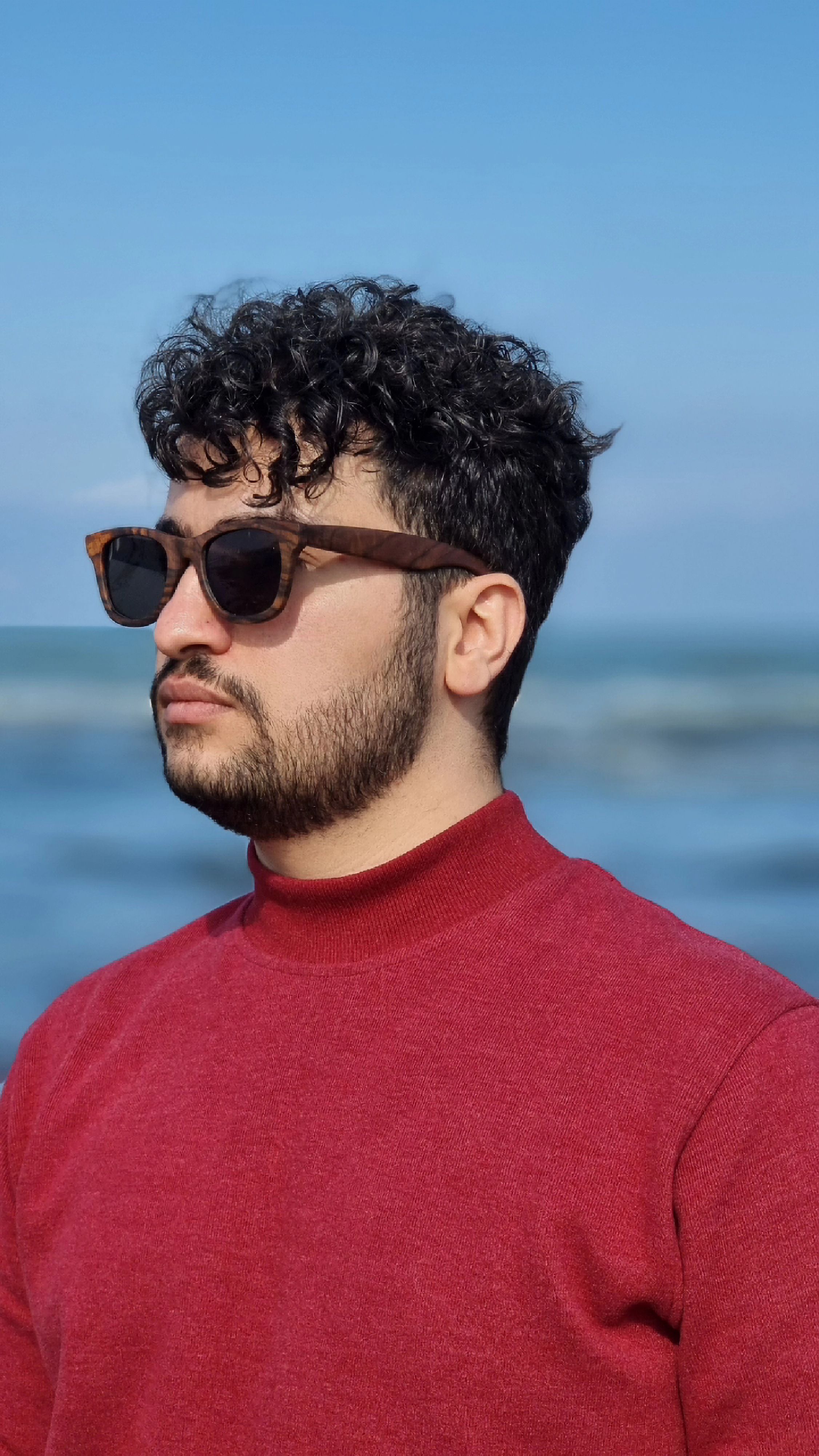 Man in red sweater with sunglasses at the Caspian Sea in Bandar Anzali.