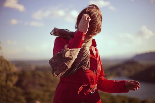 Woman in Red Long-sleeved Top Holding Head