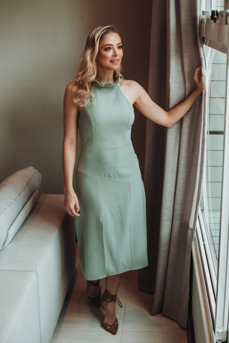 Woman In Simple Dress Standing By Window