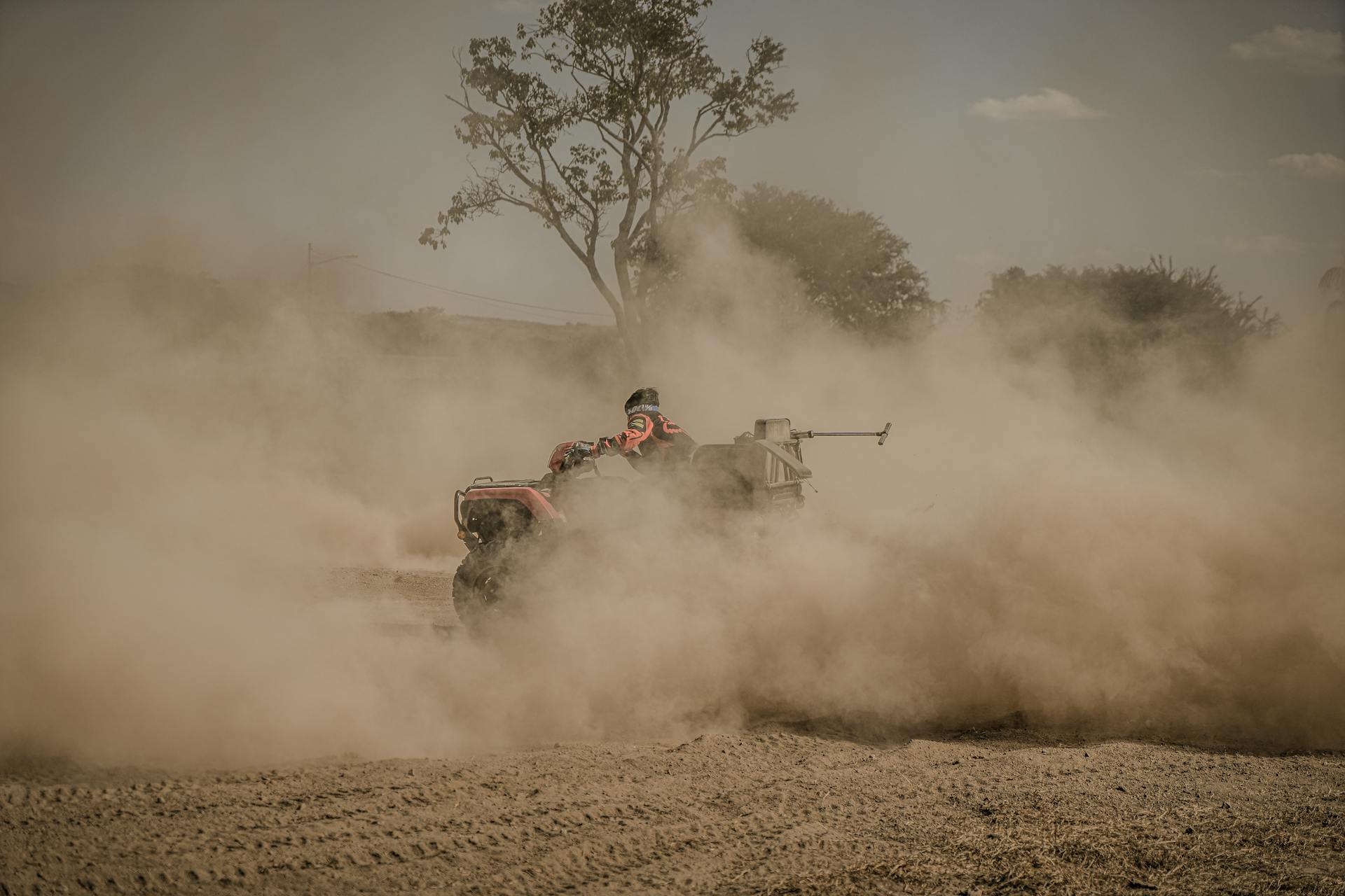 Experience the thrill of quad biking in a dusty outdoor setting, perfect for adventure seekers.