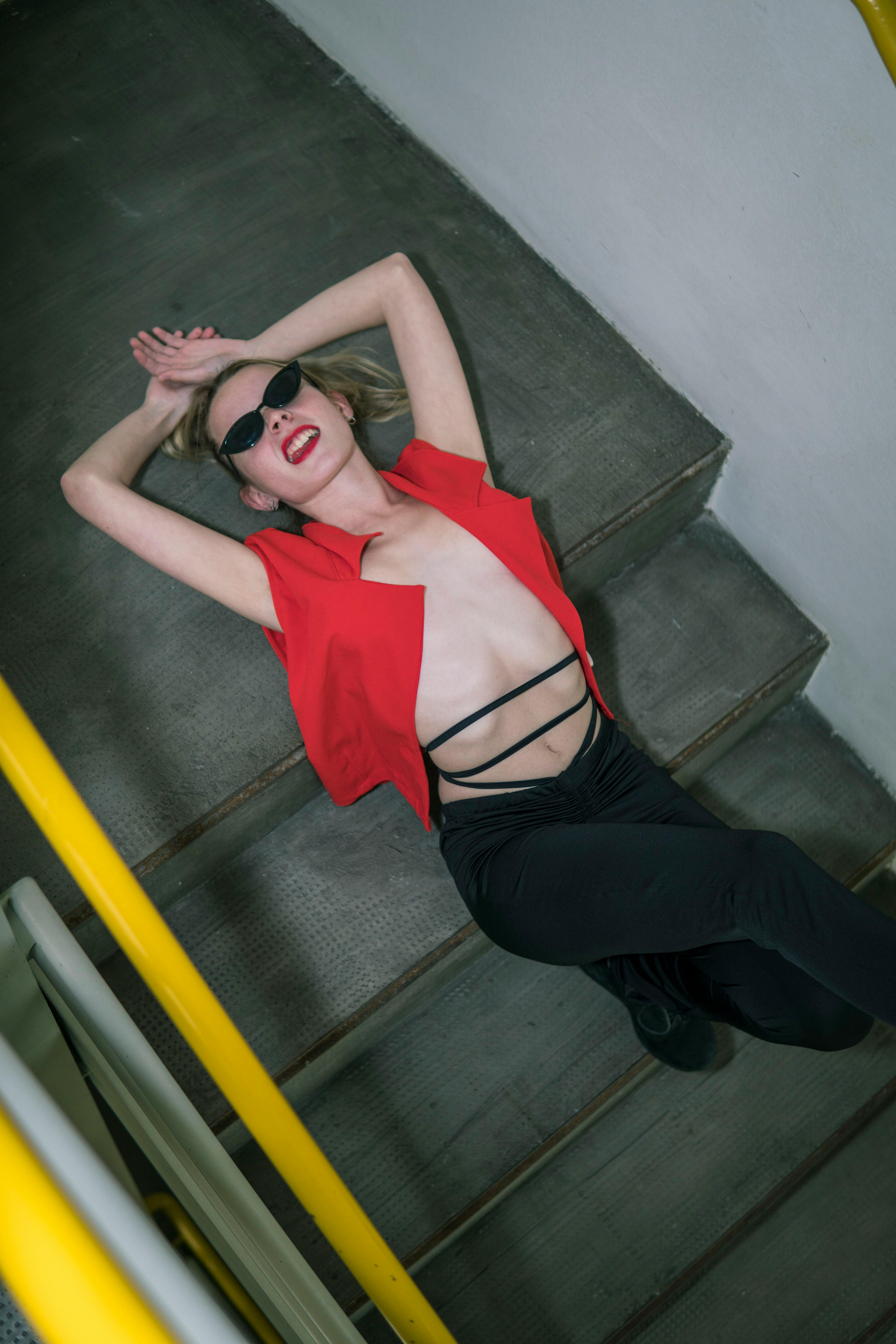 Woman in Bra Lying Down on Stairs · Free Stock Photo