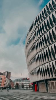 View of the San Mamés Stadium's modern facade and surrounding urban area in Bilbao, Spain.