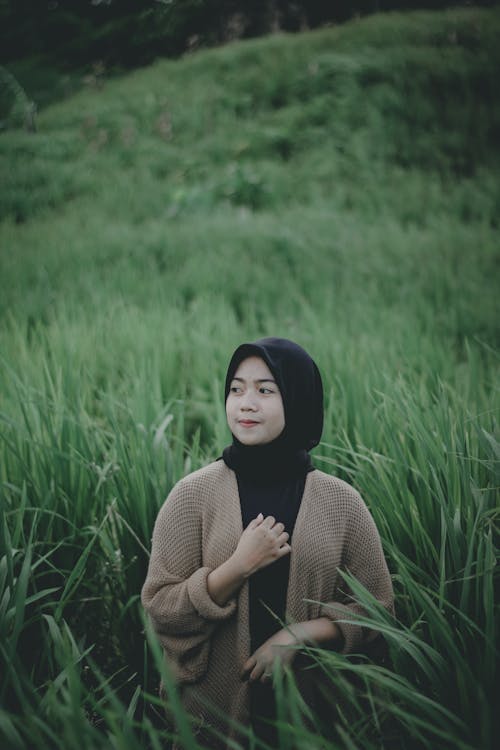 Woman in Hijab Standing on Grassland