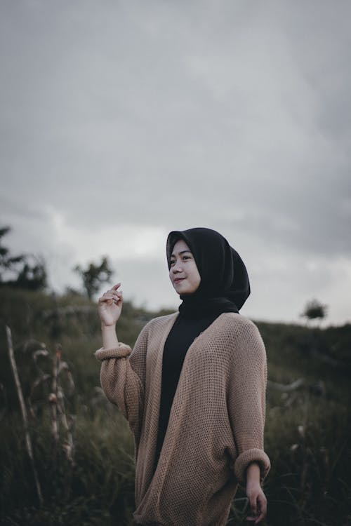 Woman in Hijab Standing on Meadow