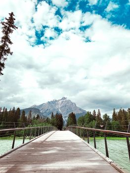 Stunning footbridge leading to mountain vista in Banff National Park, Canada.