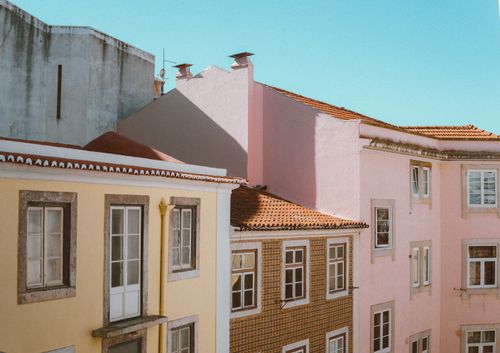 Free Beautiful pastel buildings in Lisbon's Alfama district on a sunny day. Stock Photo