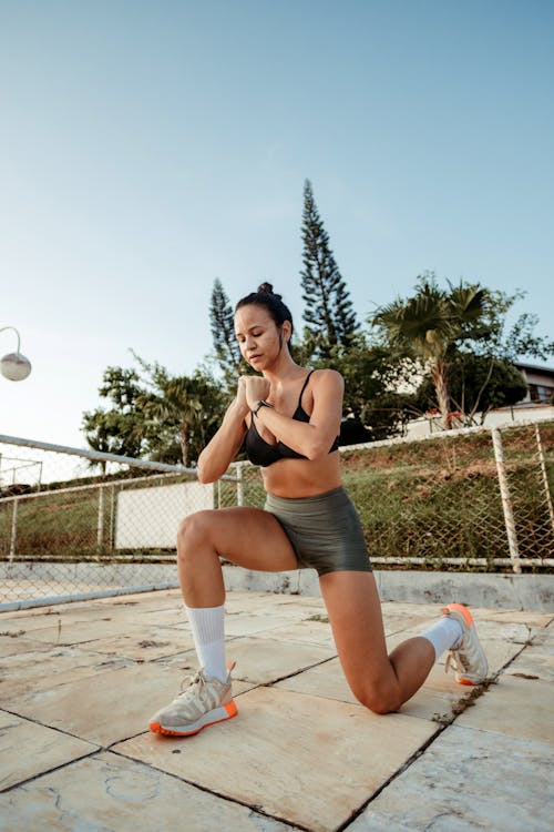 A woman doing squats in a park