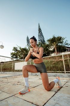 A woman performs a single-leg squat outdoors, embodying health and fitness.