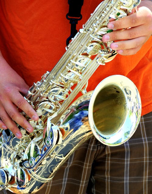 Saxophone player performing outdoors.