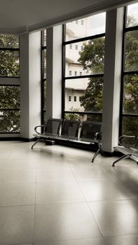 Spacious indoor room with metal seats and large windows in Malang, Indonesia.