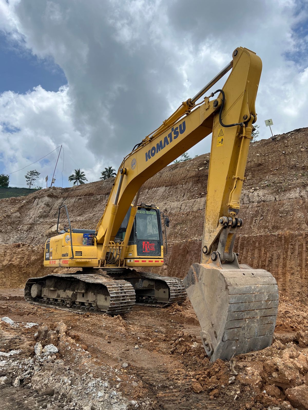 Earthmoving machine and trucks on an open site