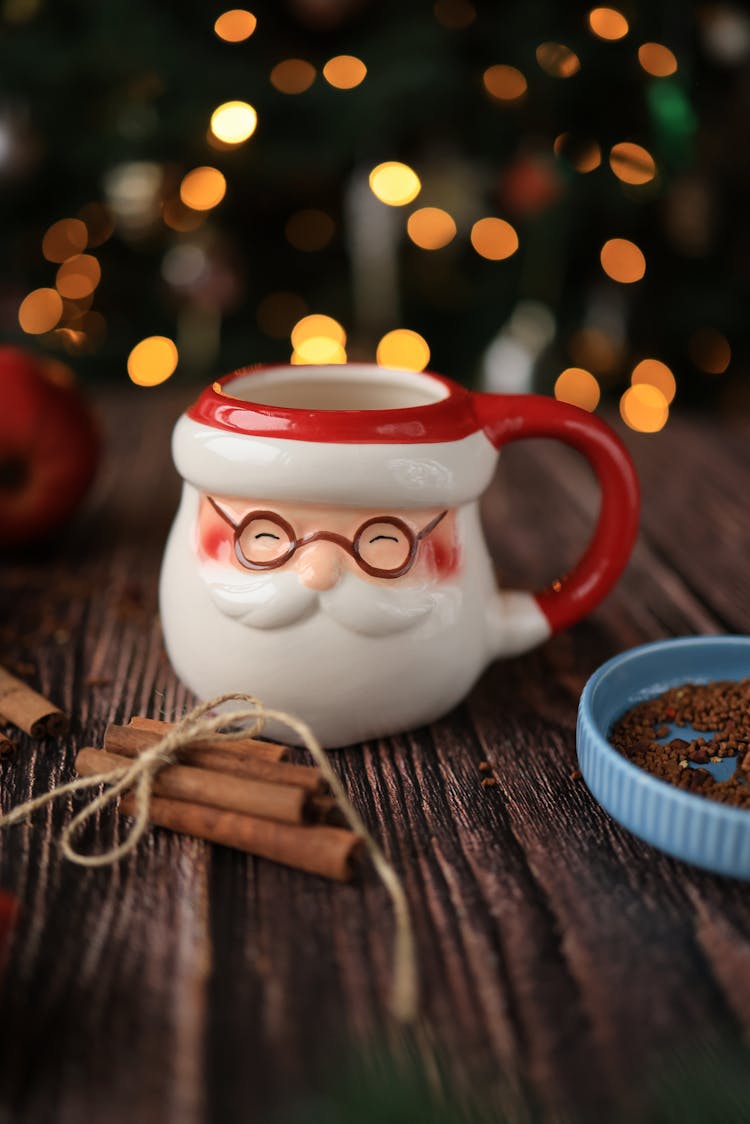 Mug In Shape Of The Santa Clause Head, Cinnamons, An Apple, Lights And Chocolate Sprinkles