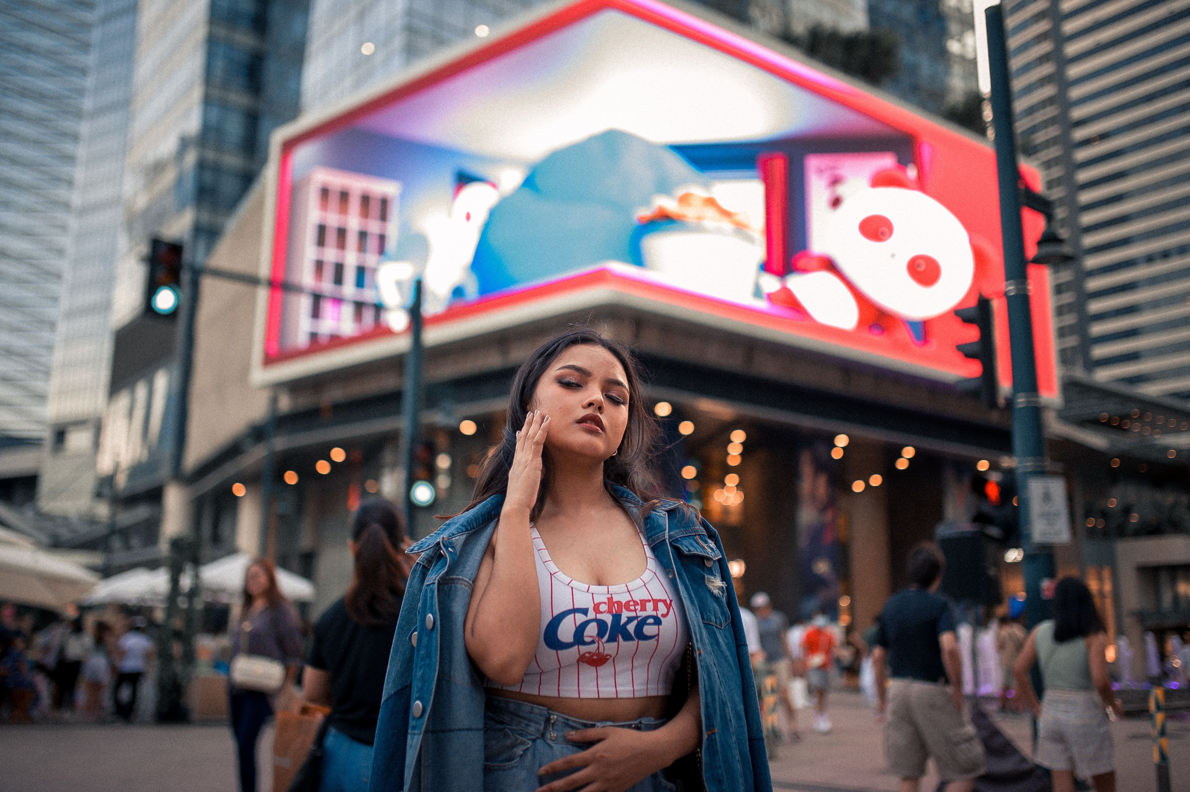 Woman Posing near Advertisement in City · Free Stock Photo