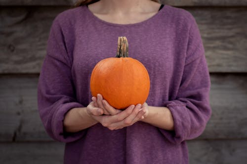 Free Photo of Woman Carrying Pumpkin on Both Hands Stock Photo