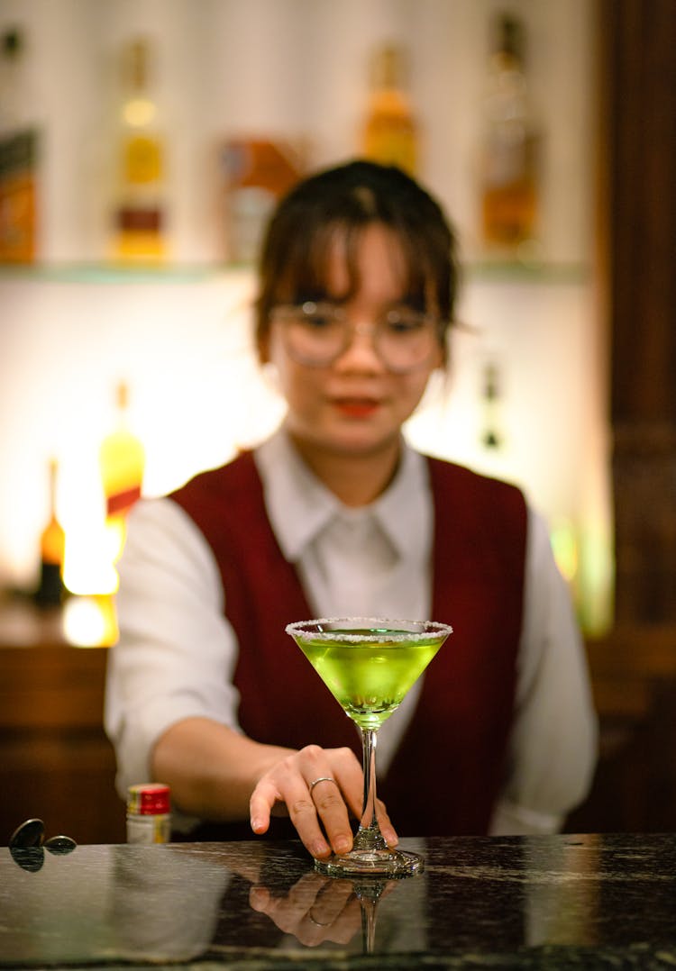 A Bartender Serving A Cocktail 