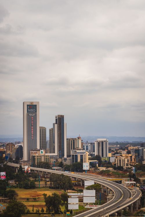 Free Aerial cityscape of Nairobi, Kenya showcasing skyscrapers and highways under an overcast sky. Stock Photo