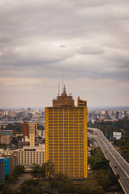 Nairobi buildings beside the highway under heavy cloud