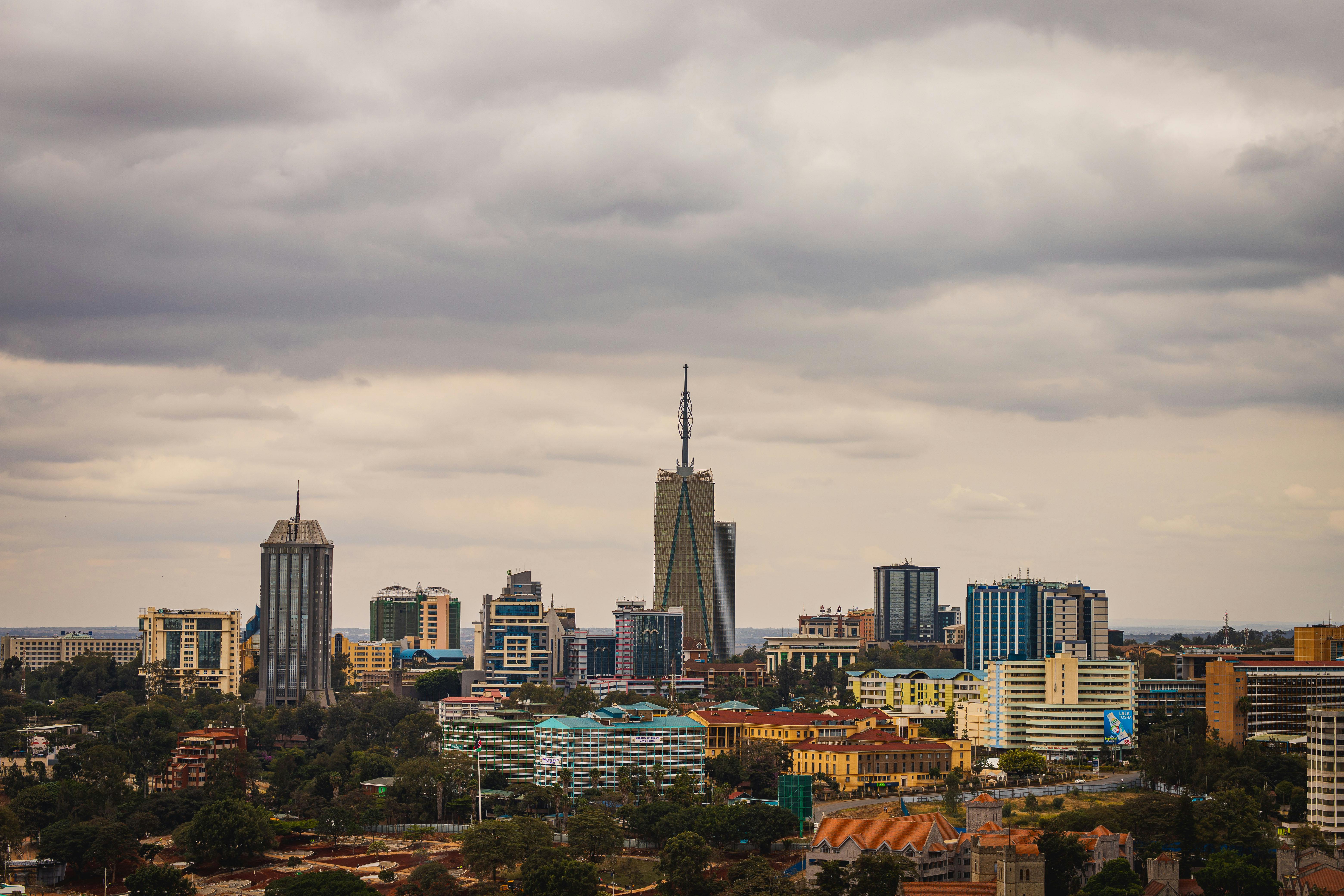 Explore the vibrant skyline of Nairobi with its modern skyscrapers under an overcast sky.